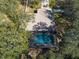 Aerial photo of a pool home nestled in a private, tree-lined backyard at 12005 Wren Ct, New Port Richey, FL 34654
