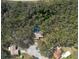 Aerial view showcases home with pool surrounded by mature trees for privacy and shade at 12005 Wren Ct, New Port Richey, FL 34654