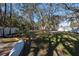 Spacious, fenced backyard offering privacy and plenty of space for recreation, surrounded by mature trees at 12005 Wren Ct, New Port Richey, FL 34654