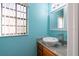 Powder room with marble countertop sink and bright window at 12005 Wren Ct, New Port Richey, FL 34654