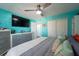Bright bedroom with stylish gray dresser, large TV, ceiling fan, and closet space at 12005 Wren Ct, New Port Richey, FL 34654