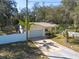 Charming one-story home with a two-car garage, well-kept lawn, and white picket fence at 12005 Wren Ct, New Port Richey, FL 34654