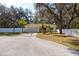 Inviting home boasting a two-car garage, tropical landscaping, and a pristine white picket fence at 12005 Wren Ct, New Port Richey, FL 34654