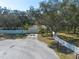 Single Gathering home featuring mature trees, a two-car garage, and a pristine front yard at 12005 Wren Ct, New Port Richey, FL 34654