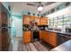 View of the kitchen, featuring wooden cabinets, stainless appliances, and blue countertops at 12005 Wren Ct, New Port Richey, FL 34654