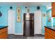 View of the kitchen with stainless steel refrigerator and access to pantry at 12005 Wren Ct, New Port Richey, FL 34654