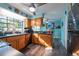 View of the kitchen with wooden cabinets, stainless appliances, and access to the dining area at 12005 Wren Ct, New Port Richey, FL 34654