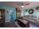 Inviting living room featuring stylish decor, a modern ceiling fan, and comfortable seating at 12005 Wren Ct, New Port Richey, FL 34654