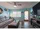 Bright living room with stylish decor, wood-look floors, and natural light from large windows at 12005 Wren Ct, New Port Richey, FL 34654