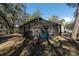 Backyard featuring a screened-in pool area, surrounded by mature trees at 12005 Wren Ct, New Port Richey, FL 34654