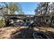 Outdoor screen-enclosed pool and seating with a large backyard area at 12005 Wren Ct, New Port Richey, FL 34654