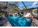 Inviting pool area with outdoor seating, perfect for relaxation and entertaining at 12005 Wren Ct, New Port Richey, FL 34654