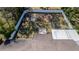 Aerial view of backyard with mature trees, stone patio and fire pit at 1316 W Hiawatha St, Tampa, FL 33604
