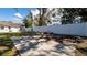 Backyard area featuring a sitting area with bench and adjacent fence at 1316 W Hiawatha St, Tampa, FL 33604
