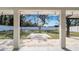 Inviting backyard featuring a covered patio and expansive lawn area with mature tree at 1316 W Hiawatha St, Tampa, FL 33604