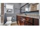 Bathroom featuring a vanity with granite countertop, toilet, and large framed mirror above sink at 1316 W Hiawatha St, Tampa, FL 33604