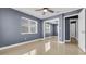 A bedroom with neutral walls, tile flooring, ceiling fan, and mirrored closet door at 1316 W Hiawatha St, Tampa, FL 33604
