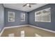 A well-lit bedroom featuring neutral walls and tile flooring, complemented by a ceiling fan at 1316 W Hiawatha St, Tampa, FL 33604