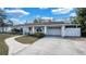 View of home showcasing a paved driveway and well-maintained landscaping at 1316 W Hiawatha St, Tampa, FL 33604