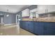 Kitchen boasts blue lower cabinets, granite countertops, and sliding door access to the yard at 1316 W Hiawatha St, Tampa, FL 33604
