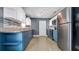 Well-lit kitchen boasts blue base cabinets, white upper cabinets, and stainless steel appliances at 1316 W Hiawatha St, Tampa, FL 33604