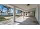 Inviting outdoor patio featuring tile flooring, a covered area, and an open view of the fenced backyard at 1316 W Hiawatha St, Tampa, FL 33604