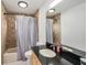 Bathroom featuring a dark countertop, shower and tub combo, and a tile accent wall at 15742 Scrimshaw Dr, Tampa, FL 33624