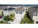 Aerial view of a gray two-story home with dark shutters and a well-maintained lawn at 16849 Trite Bend St, Wimauma, FL 33598