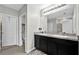 A spacious bathroom with dual sink vanity, a large mirror and tiled floor at 16849 Trite Bend St, Wimauma, FL 33598