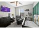 Bedroom featuring chair, crib, dresser, decor, and accent wall at 16849 Trite Bend St, Wimauma, FL 33598
