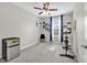 Bedroom featuring a ceiling fan, a window, a tv and a small refrigerator at 16849 Trite Bend St, Wimauma, FL 33598
