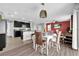 Open floorplan with dining area, eat-in kitchen, and luxury vinyl plank flooring at 16849 Trite Bend St, Wimauma, FL 33598
