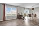 Sunlit dining room featuring luxury vinyl plank flooring and large windows with custom window treatments at 16849 Trite Bend St, Wimauma, FL 33598