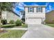 Beautiful two-story home with a spacious driveway, manicured lawn, and gray exterior paint at 16849 Trite Bend St, Wimauma, FL 33598