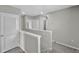 Bright hallway with neutral walls and carpet, and white-painted trim at 16849 Trite Bend St, Wimauma, FL 33598