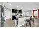 Eat-in kitchen featuring granite countertops, stainless appliances, and breakfast bar with stool seating at 16849 Trite Bend St, Wimauma, FL 33598