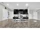 Modern kitchen with stainless steel appliances, granite countertops and black cabinetry at 16849 Trite Bend St, Wimauma, FL 33598