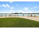 Lagoon beach featuring adirondack chairs and sandy shoreline on a sunny day at 16849 Trite Bend St, Wimauma, FL 33598