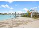 View of the Lagoon beach featuring water slide and beachgoers at 16849 Trite Bend St, Wimauma, FL 33598