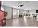 Open floorplan showing living area flowing into dining and eat-in kitchen with luxury vinyl plank flooring at 16849 Trite Bend St, Wimauma, FL 33598