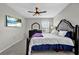 Comfortable main bedroom featuring a ceiling fan and mounted television at 16849 Trite Bend St, Wimauma, FL 33598