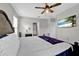 Spacious main bedroom featuring a ceiling fan and doorway to an ensuite at 16849 Trite Bend St, Wimauma, FL 33598
