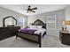 A beautiful main bedroom featuring a ceiling fan, two windows and neutral walls at 16849 Trite Bend St, Wimauma, FL 33598