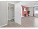 Bright main bedroom featuring wood-look floors, a ceiling fan and adjoining ensuite at 16849 Trite Bend St, Wimauma, FL 33598