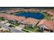 Expansive aerial view of a community with homes surrounding a sparkling pond at 17105 Star Banks St, Wimauma, FL 33598