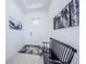 Bright entryway with white walls, decorative artwork, and a stylish bench on tile floor at 17105 Star Banks St, Wimauma, FL 33598