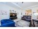 Bright living room with tile floors, comfortable leather sofas, and a large television on the wall at 17105 Star Banks St, Wimauma, FL 33598