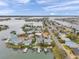 Aerial view of a waterfront community featuring private docks, boat access, and beautiful waterfront views from many homes at 17404 1St E St, Redington Shores, FL 33708