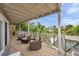 Spacious covered balcony with seating offering serene views of the canal and tropical landscaping at 17404 1St E St, Redington Shores, FL 33708