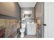 Charming half-bathroom with slate tile walls and flooring at 17404 1St E St, Redington Shores, FL 33708